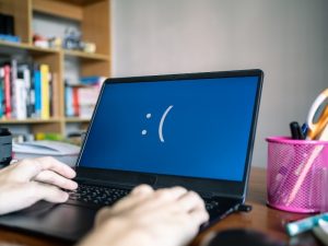 a man with a laptop flasing a down system indicating a upgrade operating system